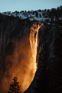 Sunset Cascade: Waterfall Illuminated in Natural Landscape