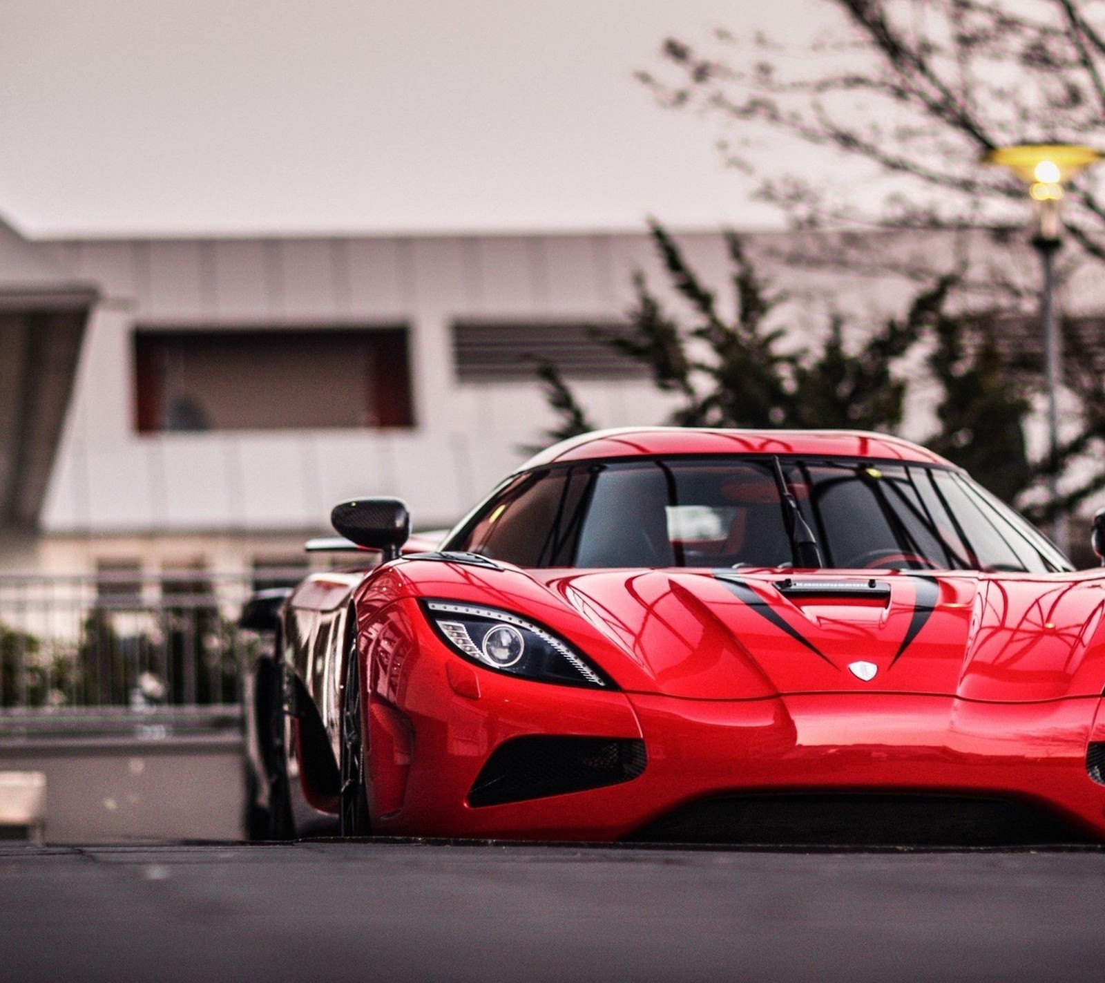 A close up of a red sports car parked on a street (agera, car, red, speed, super)