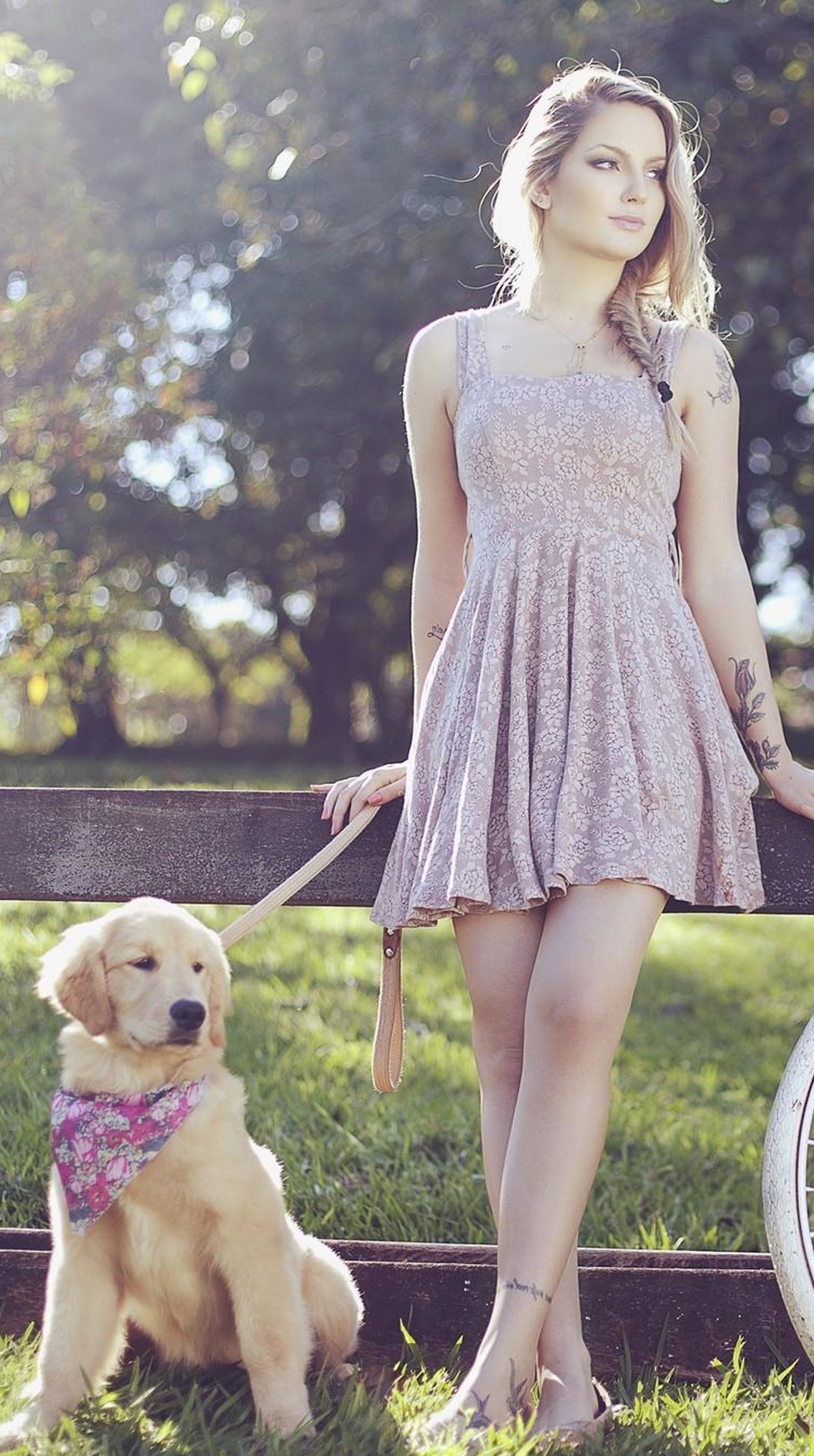 Blond woman in a dress standing next to a dog on a leash (cute, feelings, girl, love)