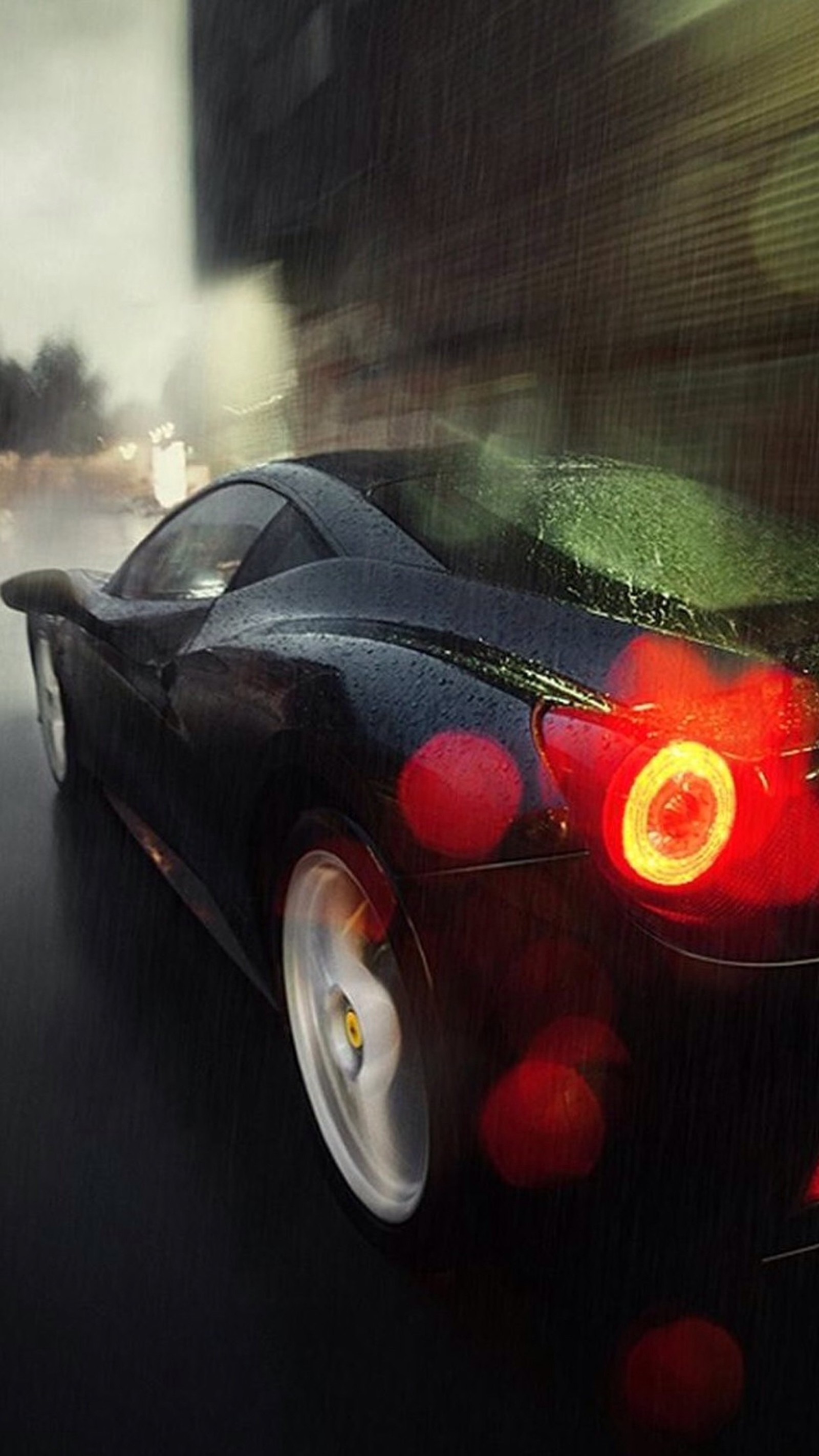 Arafed view of a black sports car driving down a city street (car, rain)