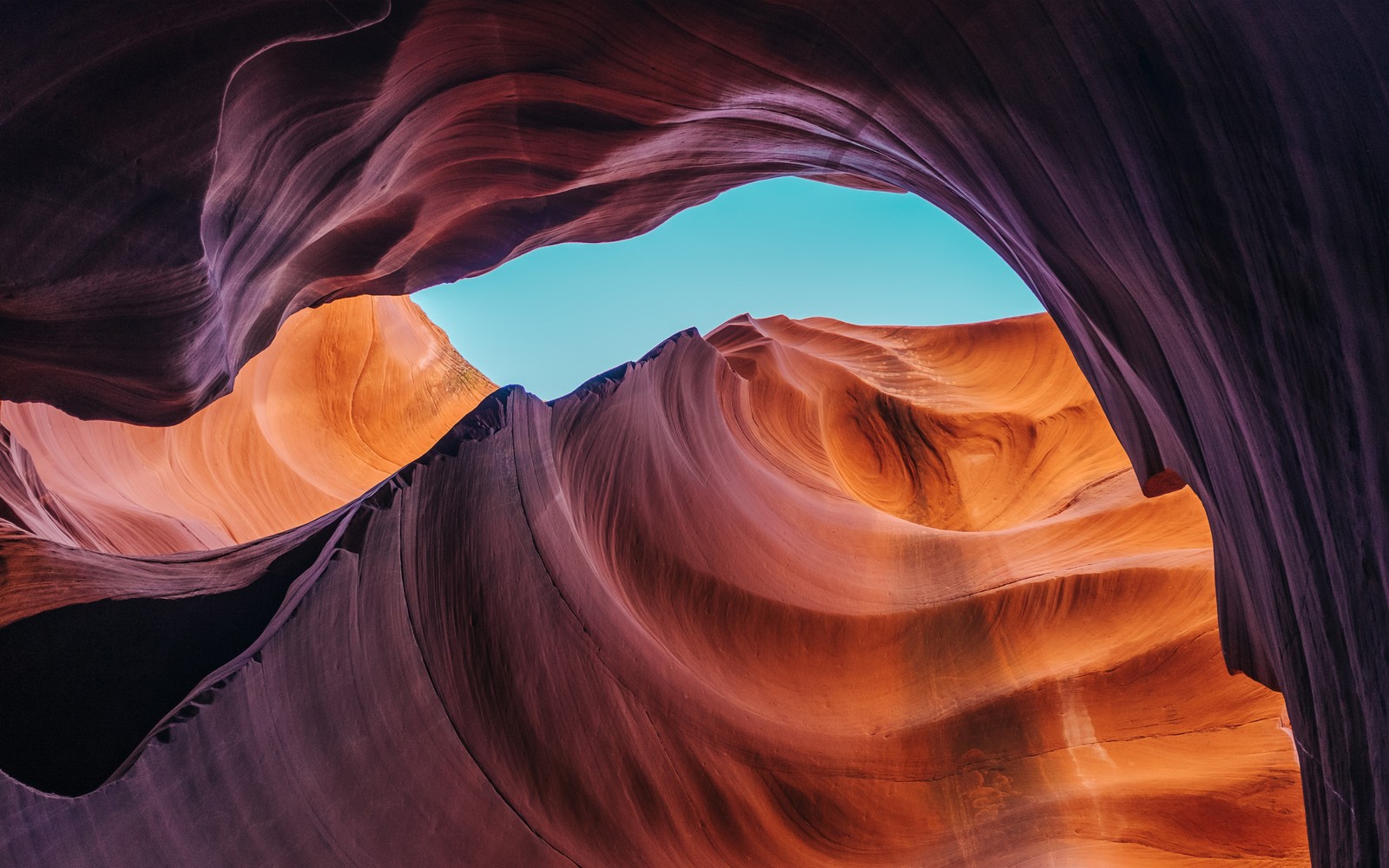 A close up of a rock formation with a blue sky in the background (canyon, purple, formation, landscape, creative arts)