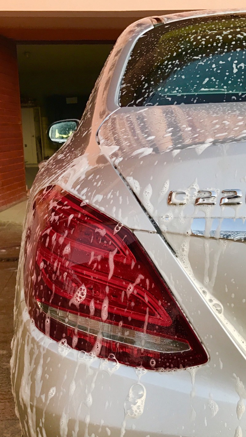 A close up of a car with a lot of water on it (amg line, c220, washing)