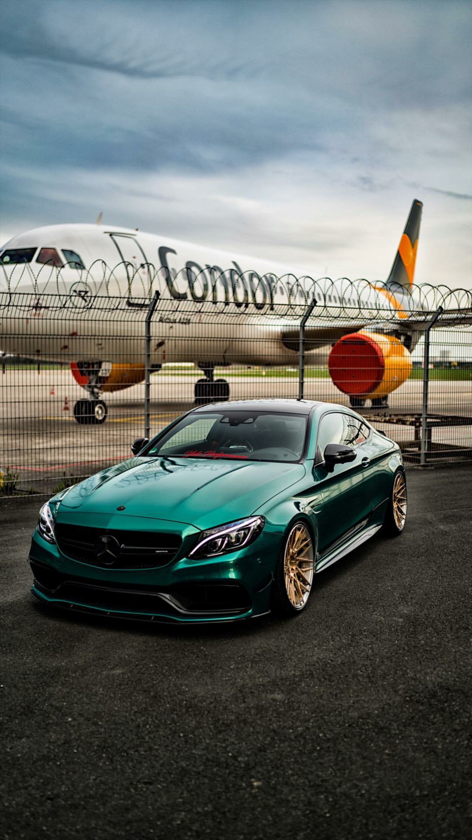 Arafed green car parked in front of a jet airliner (mercedes, amg, green, car, supercar)