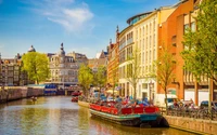 Amsterdam Canal Views: Vibrant Waterfront with Boats and Historic Architecture