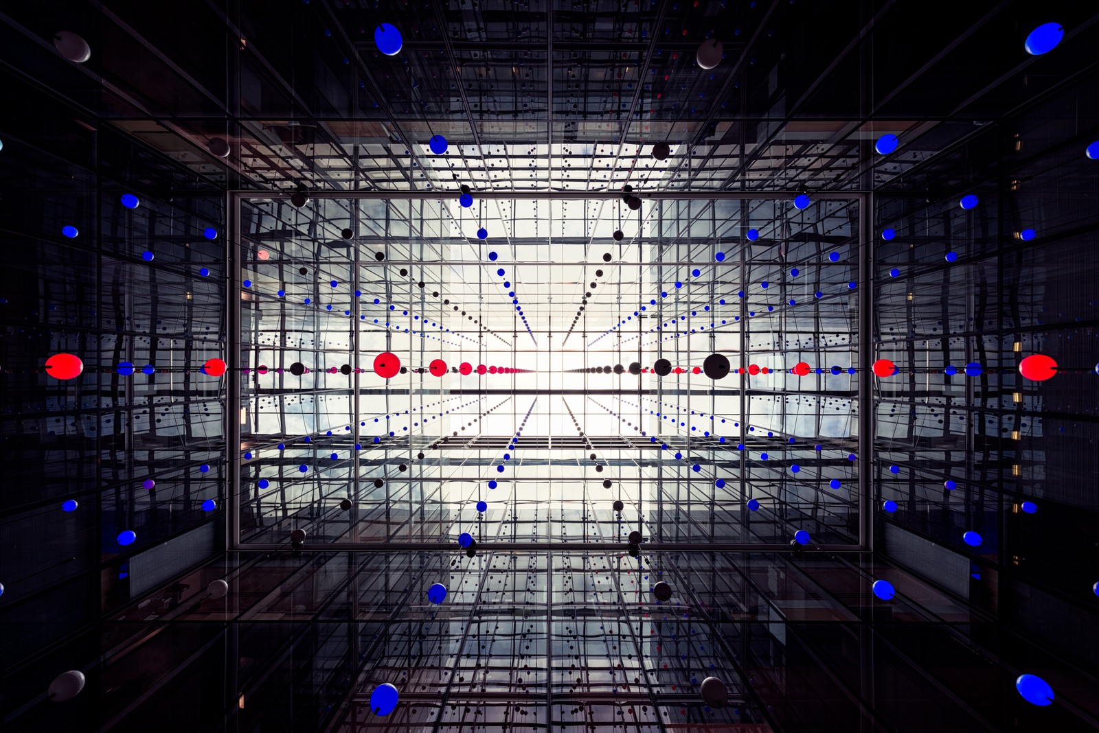 A close up of a building with a lot of lights on it (glass building, spheres, modern architecture, interior, symmetrical)