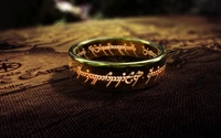 A golden ring inscribed with Elvish text, resting on an ancient map, symbolizing the allure and power of Middle-earth in "The Lord of the Rings.