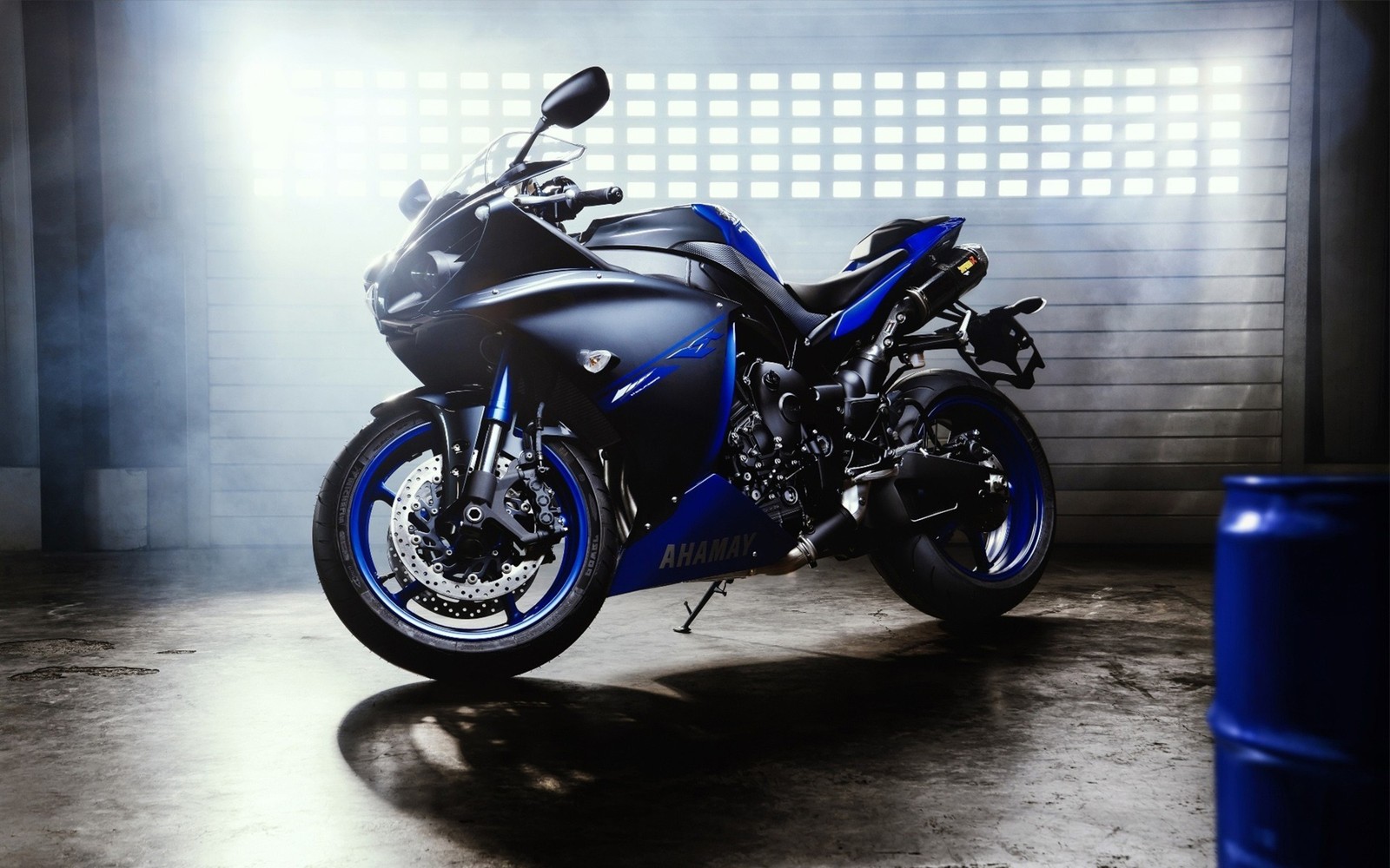 Une moto floue garée dans un garage avec un baril bleu (pneu, moto, yamaha corporation, moto de sport, yamaha motor company)