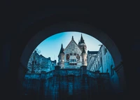 Neuschwanstein Castle: A Majestic Reflection Framed by Archways