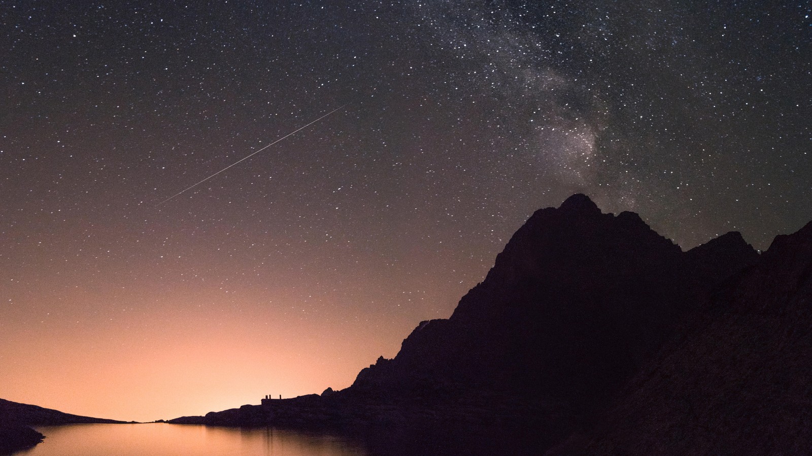 A view of a lake with a plane flying over it (night, star, atmosphere, astronomical object, astronomy)