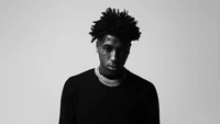 NBA YoungBoy in Monochrome: A Striking Black and White Portrait of the American Rapper.