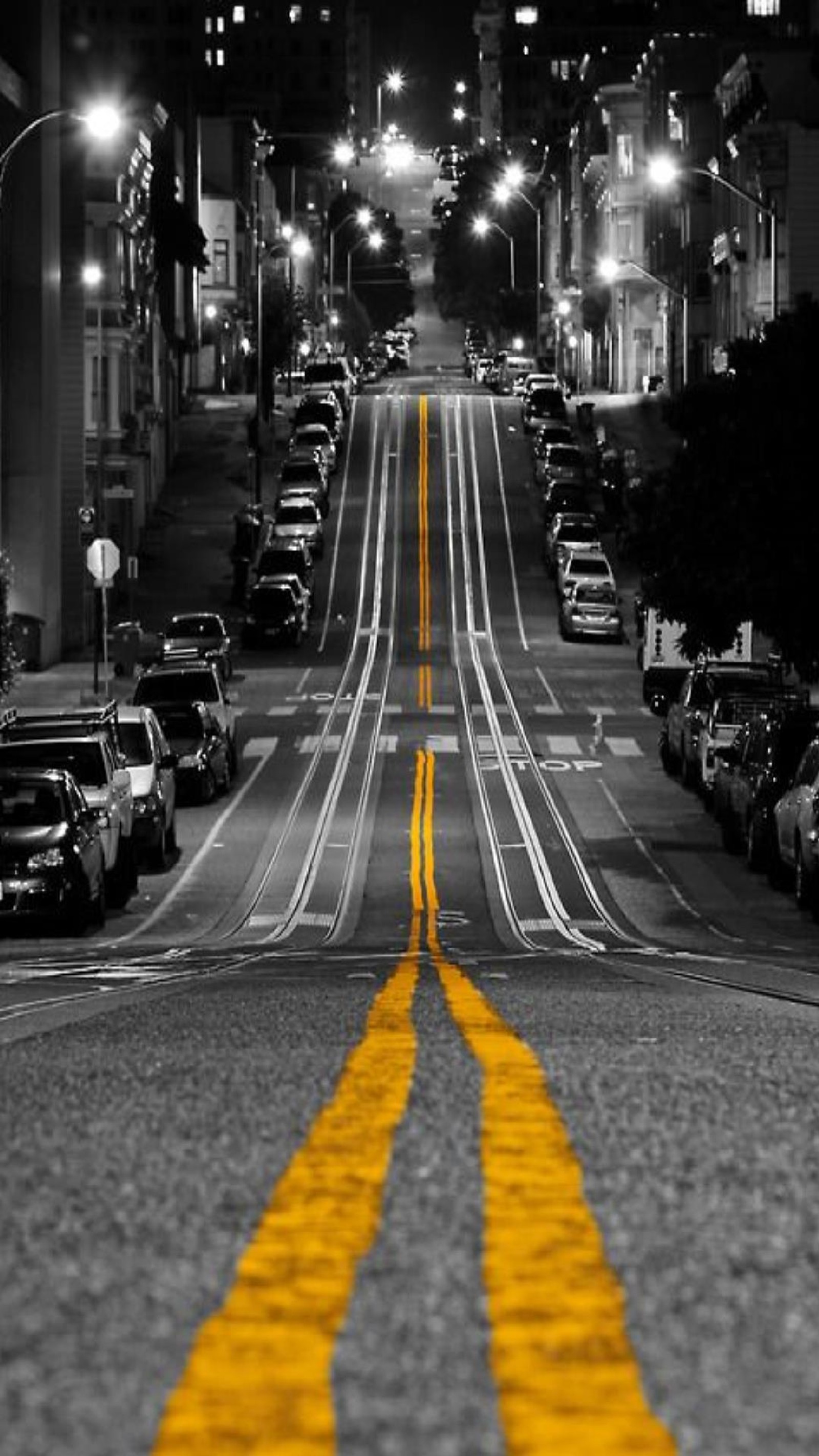 A black and white photo of a street with a yellow line (dfg, vcx)