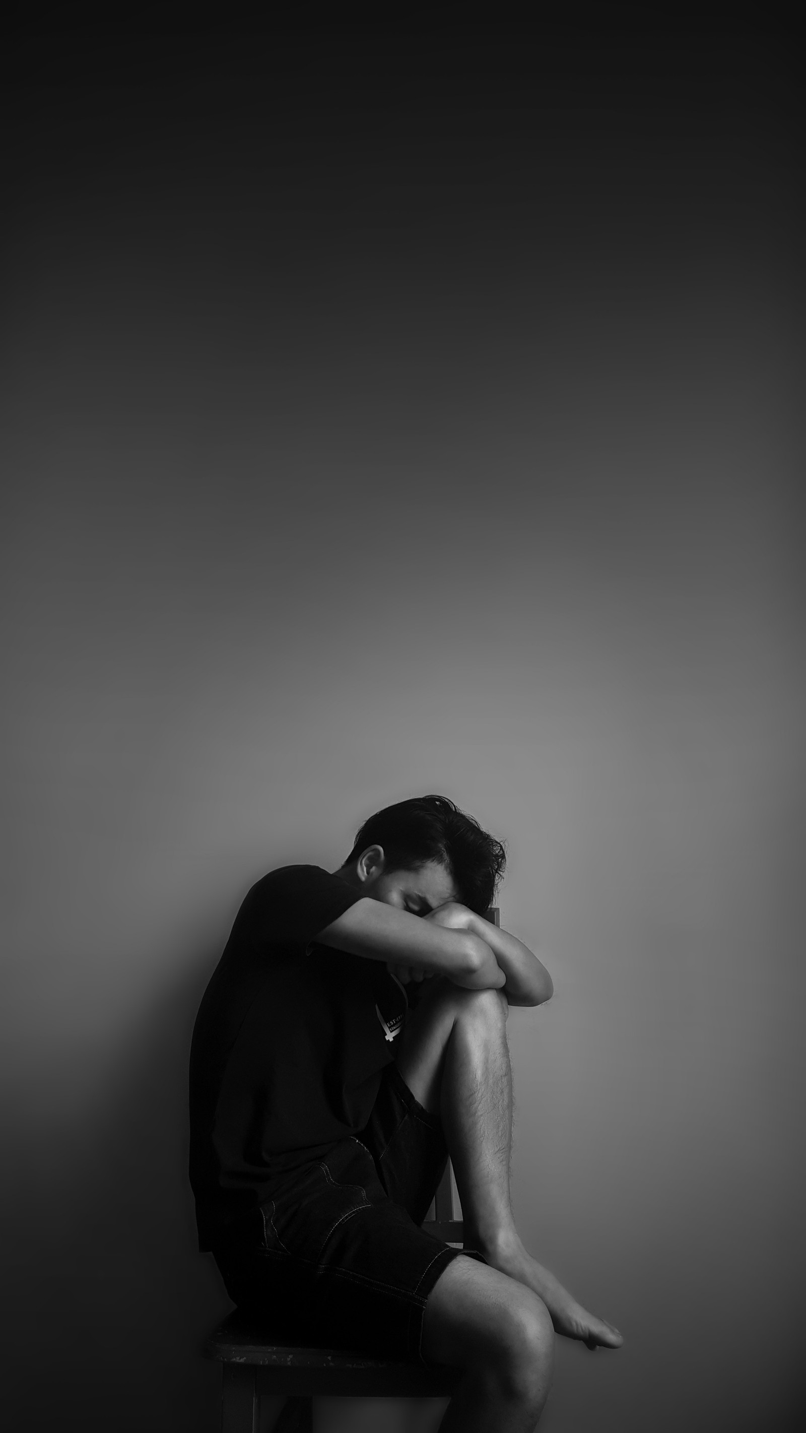 Arafed man sitting on a stool with his head in his hands (4k, boy, cry, hurt, love)