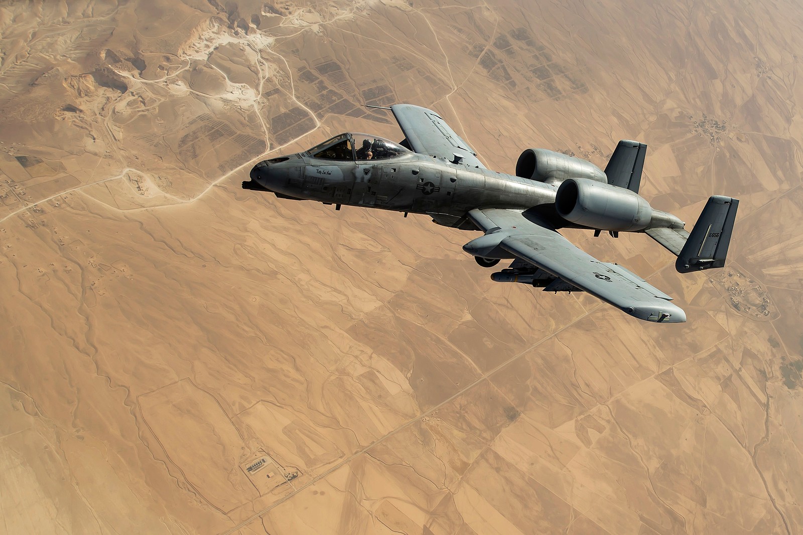 Araflane flying over a desert area with a desert area in the background (united states air force, air force, aircraft, airplane, jet aircraft)