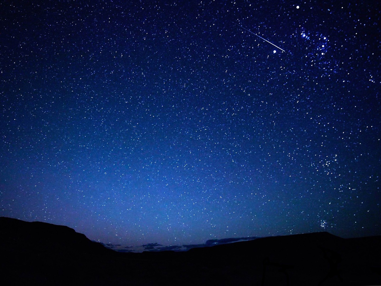 Uma vista do céu noturno com uma estrela cadente (estrela, noite, atmosfera, astronomia, objeto astronômico)