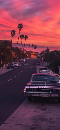 Nighttime Aesthetics: Classic Cars Beneath a Vibrant Sunset