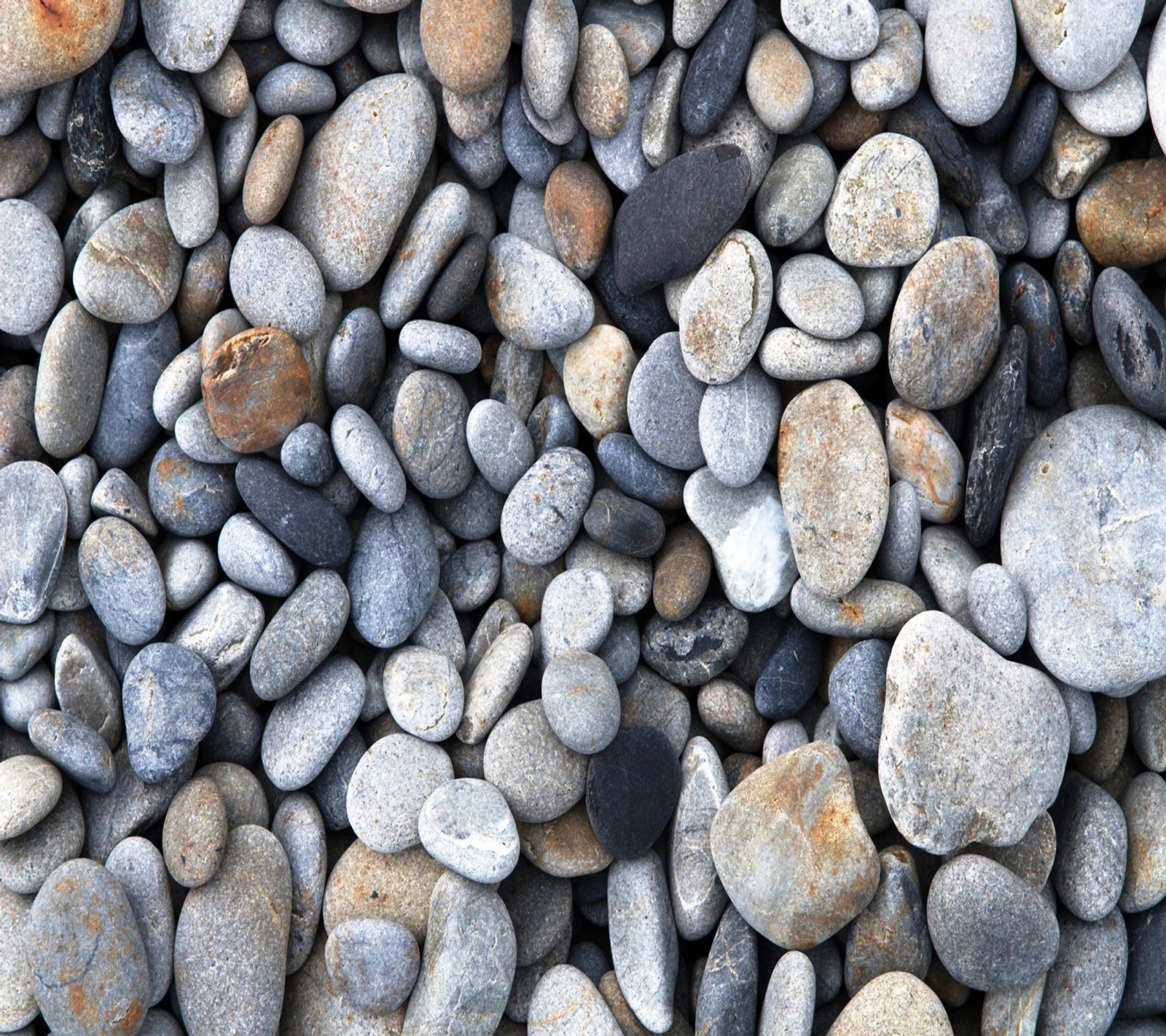 A close up of a pile of rocks with a red object in the middle (hd, nature, stones)