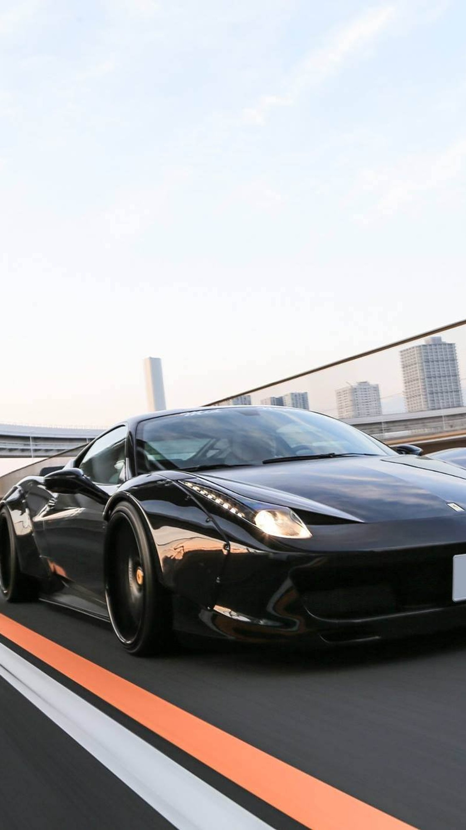 Un coche deportivo negro conduciendo por una carretera con el horizonte de la ciudad al fondo (negro, coche, new ferrari, camino)