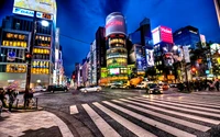 Vibrant Tokyo Cityscape at Night with Bustling Streets and Illuminated Landmarks