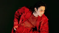 Key of SHINee in a striking red outfit, embodying confidence and charisma.