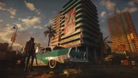 Paisaje urbano vibrante en Far Cry 6 con coche clásico y arquitectura retro