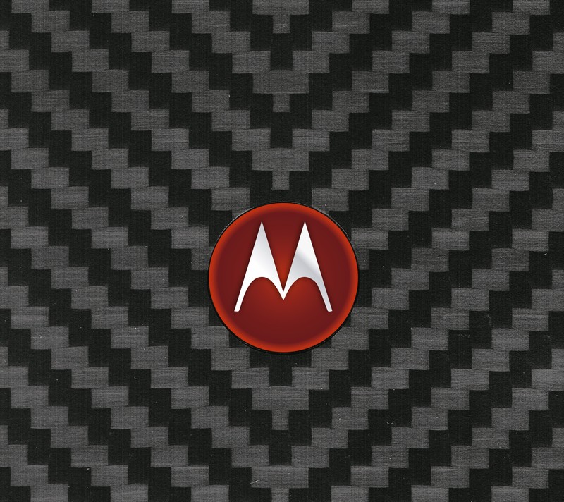 Крупный план логотипа motorola на черном и сером фоне (чёрный, углерод, серый, кевлар, kevlar)