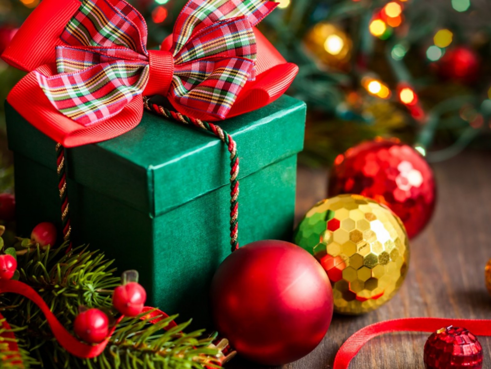 A close up of a green gift box with a red bow and ornaments (bauble christmas, gift, merry christmas, xmas)