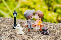 Adorable Dolls Sharing Their First Kiss on a Park Bench