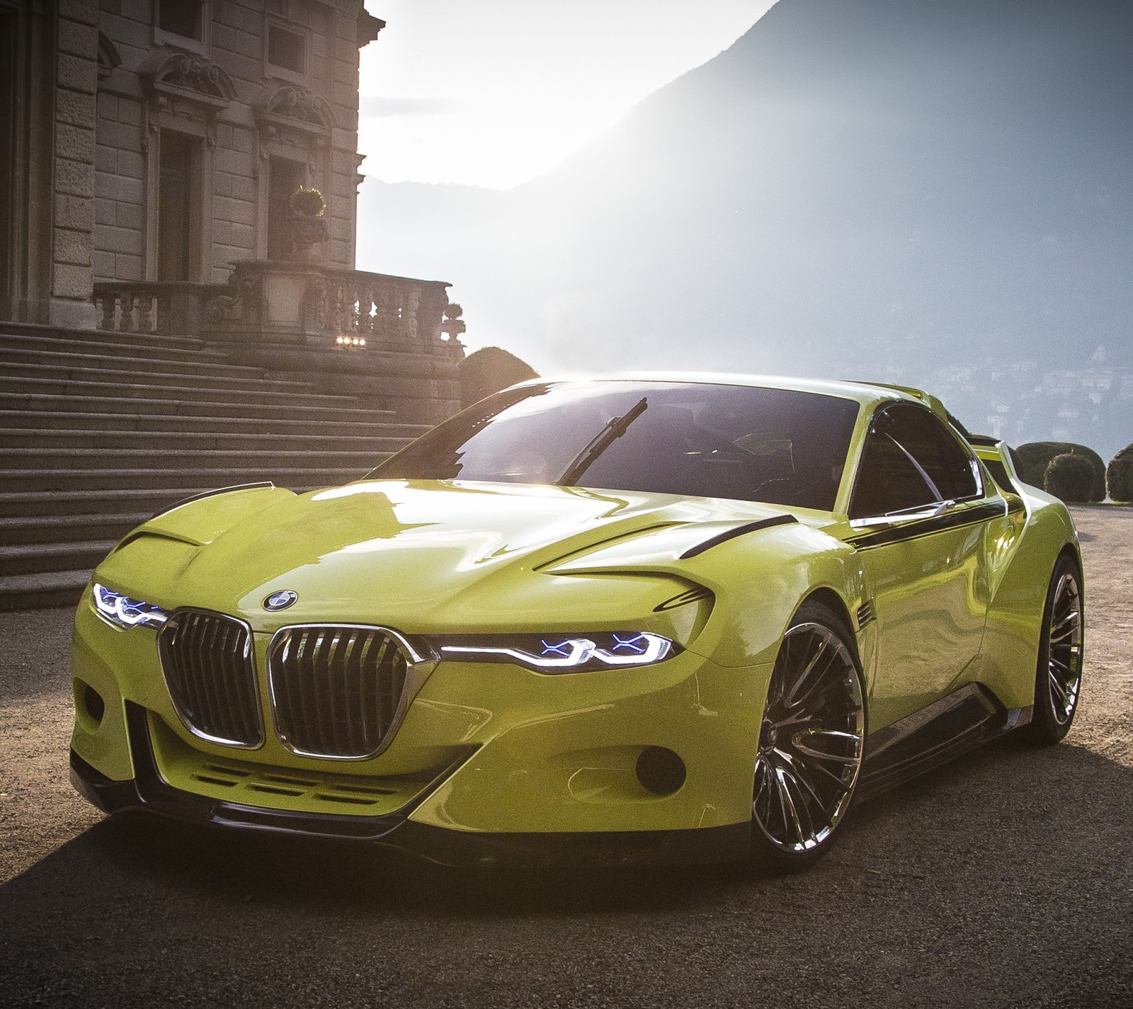 A close up of a yellow bmw sports car parked in front of a building (bmw, germany, sports, yellow)