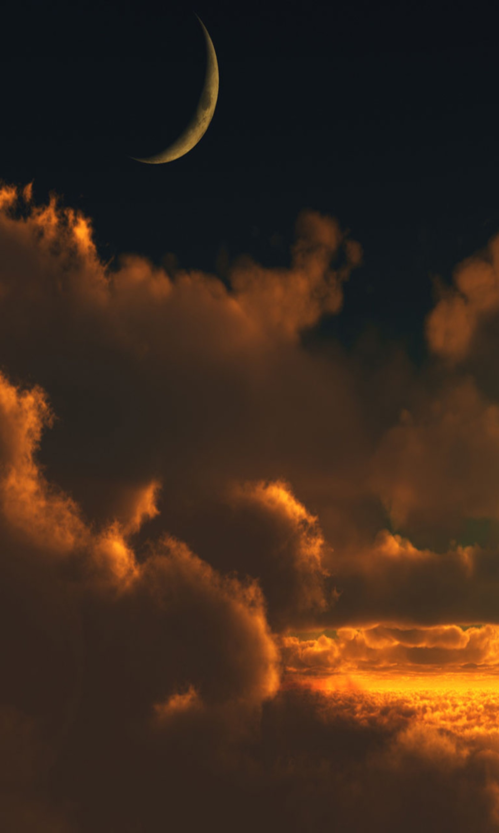 Arafed view of a crescent in the sky with a few clouds (moon, set, sun)