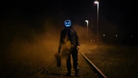 Midnight Encounter: A Figure in a Mask Amidst Smoke and Shadows on an Abandoned Track