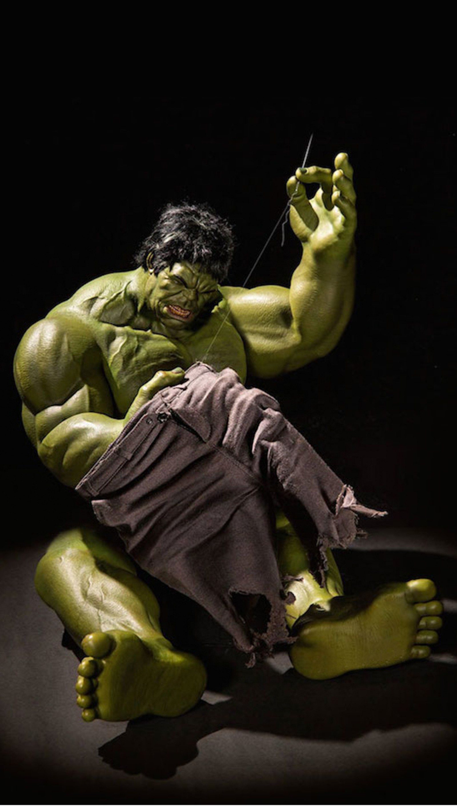 Hulk statue sitting on the ground with a knife in his hand (abstract, hulk)