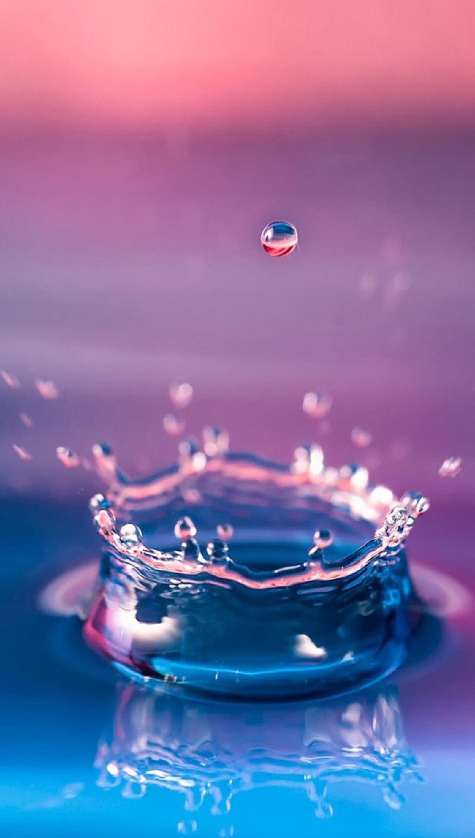 A close up of a water drop with a pink background (abstract, drop, water)