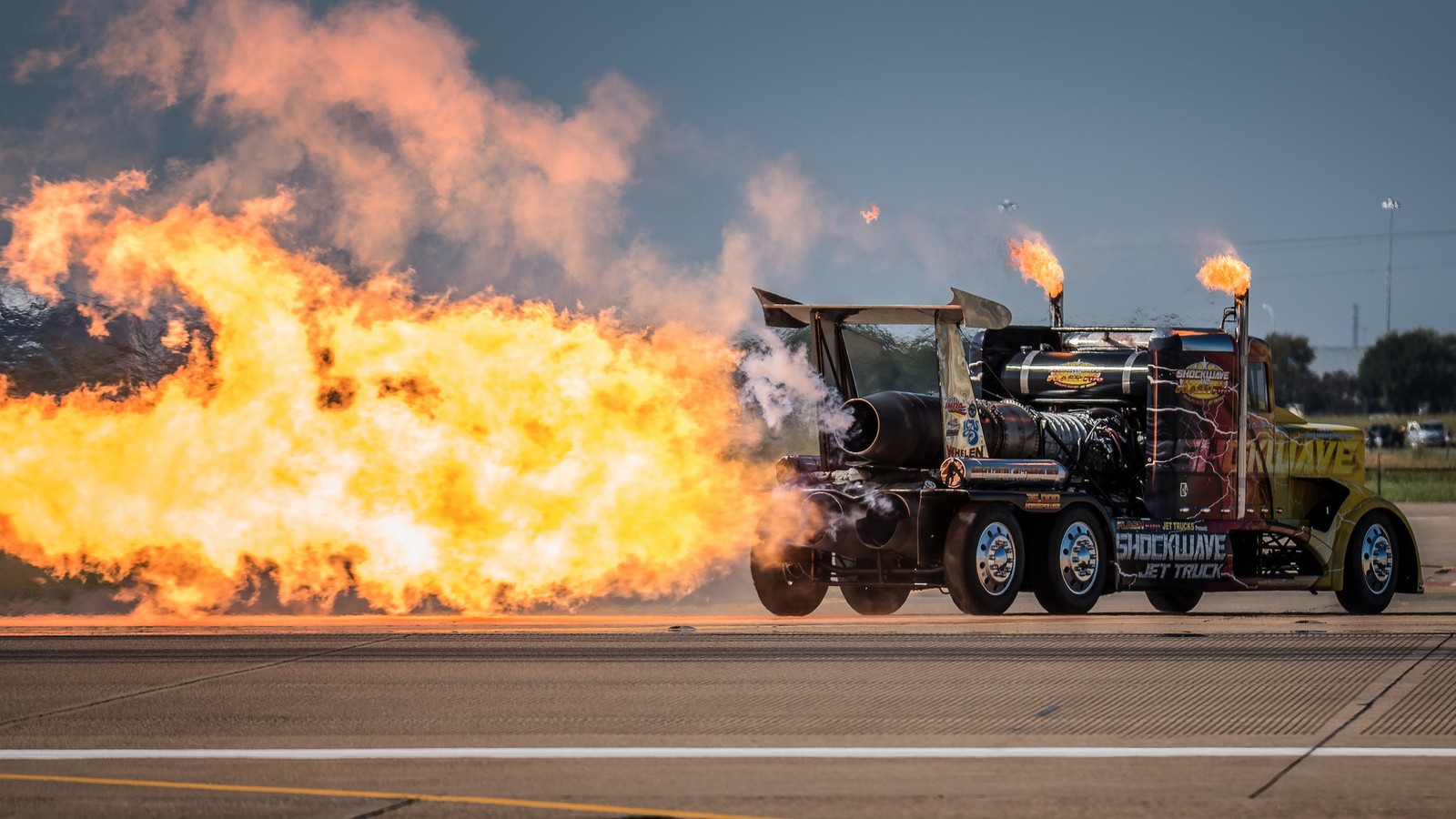 There is a large fire truck with a lot of flames coming out of it (truck, peterbilt, fire, peterbilt 379, tractor unit)