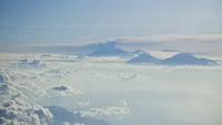 Majestosa cadeia montanhosa acima das nuvens ao amanhecer