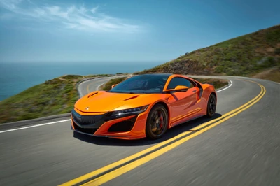 Динамичный оранжевый Acura NSX на живописной прибрежной дороге