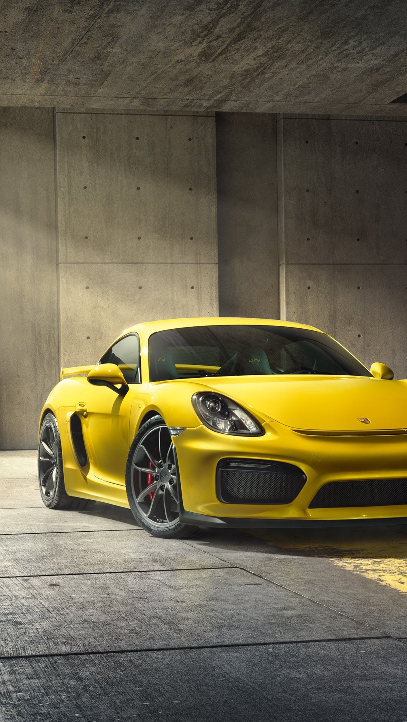 A close up of a yellow sports car parked in a parking garage (car, design, new, porsche)