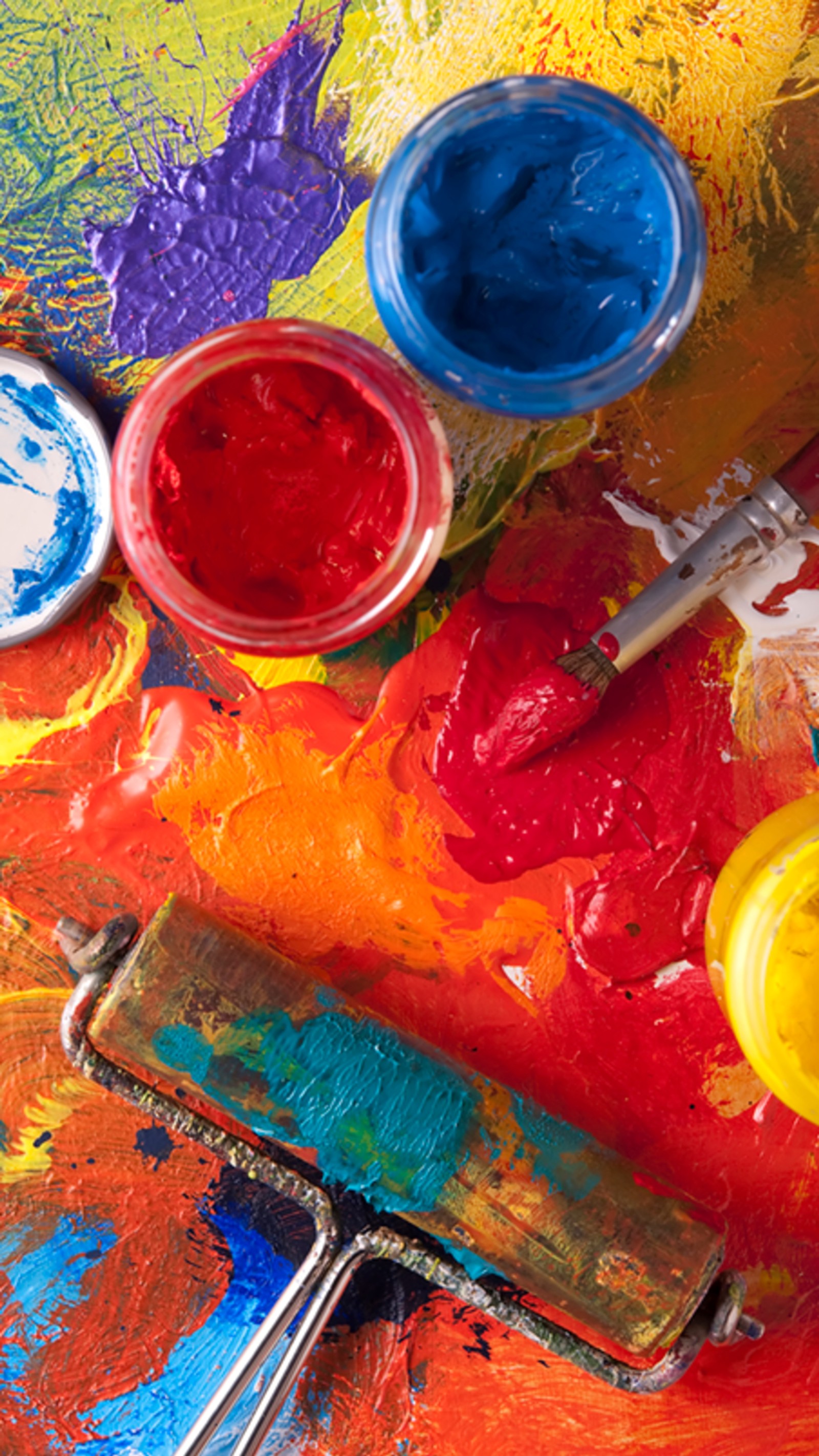 There are many paints on a colorful palette with a paint brush (acrylic paint, paint, paintbrush, colored, oil paint)