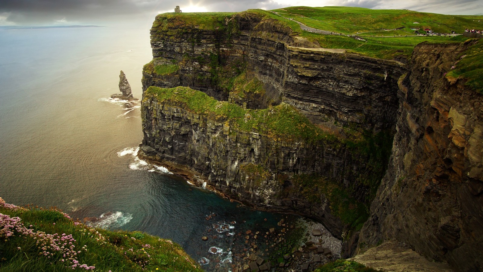 A view of a cliff with a person standing on top of it (cliffs of moher, cliff, coast, rock, klippe)