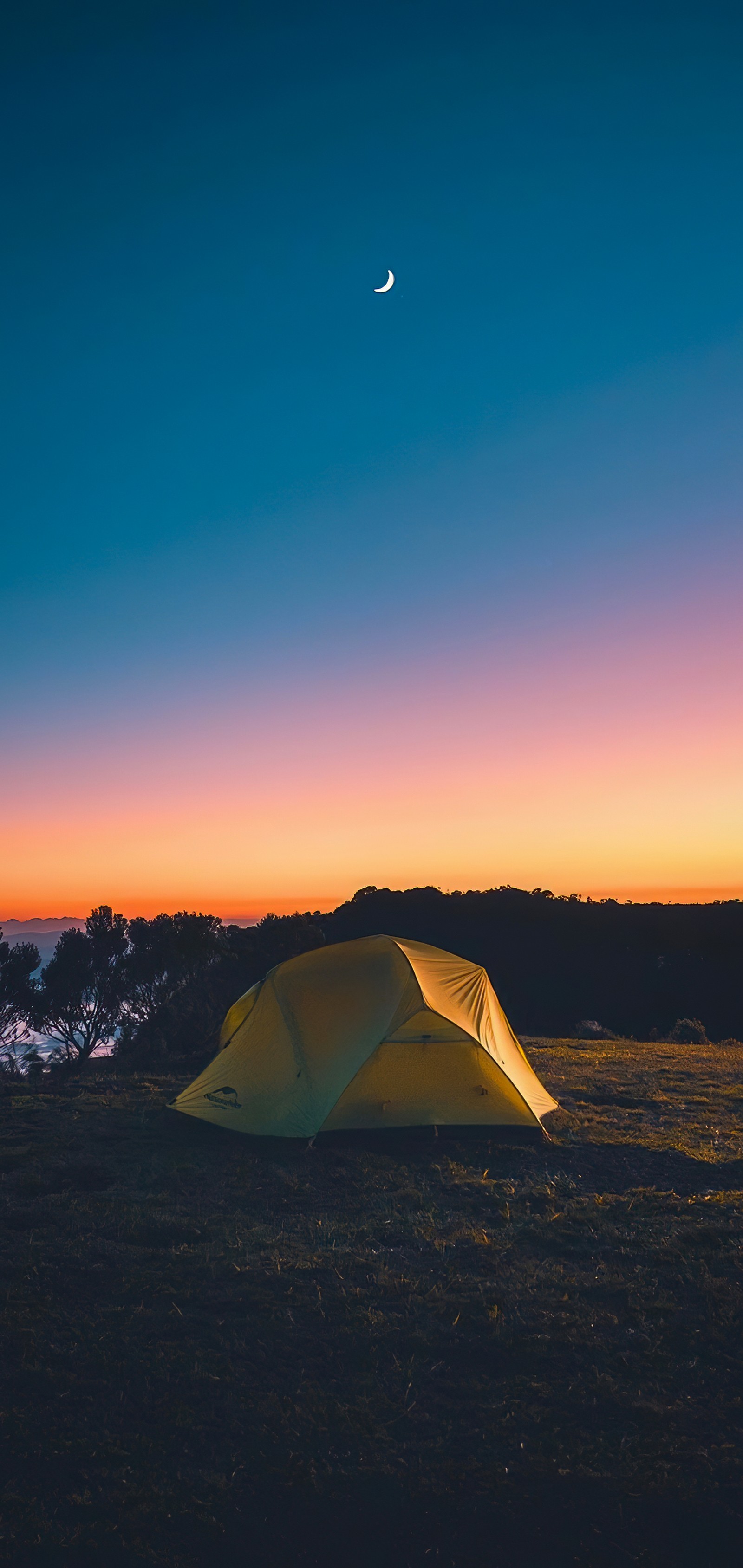 Arafed tent pitched up in a field with a crescent in the sky (atmosphere, light, moon, tent, dusk)