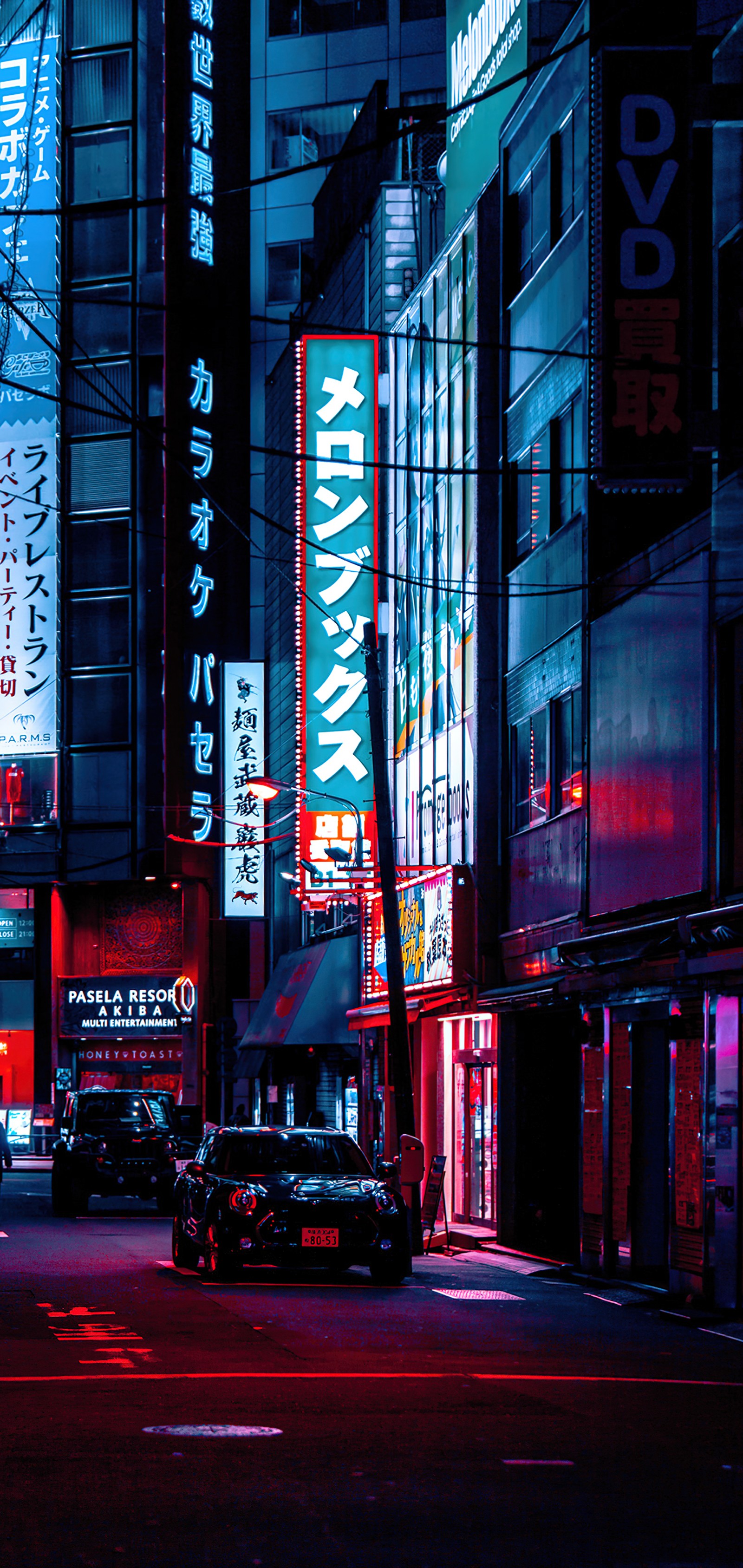 Arafed view of a city street at night with neon signs (building, cars, light, blue, automotive lighting)