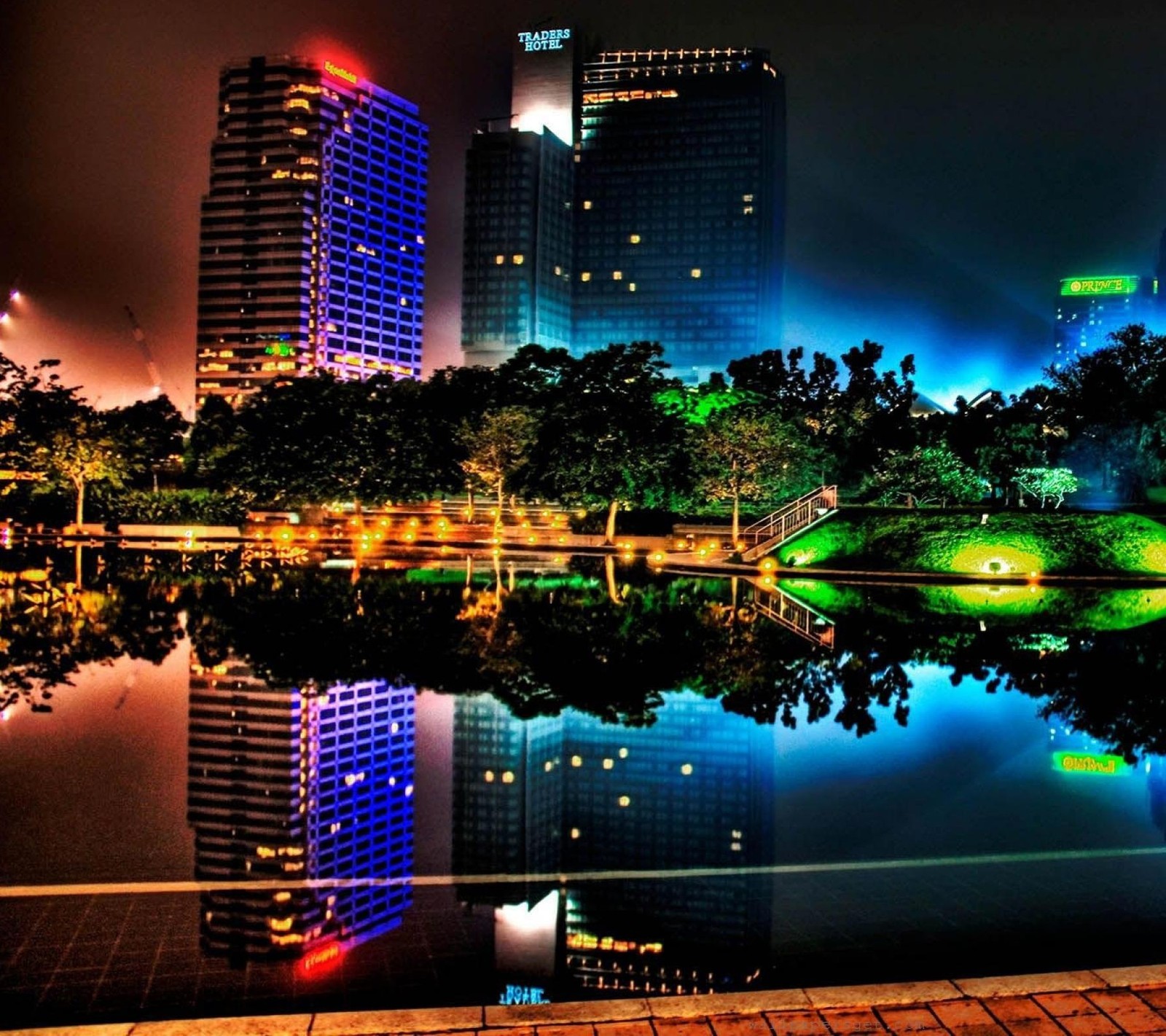 Nighttime view of a city with a lake and a bridge (beautiful, city, color, lights, neon)