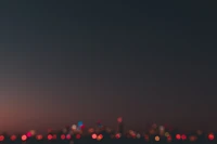 Red-lit Buildings Against a Darkening Sky at Night