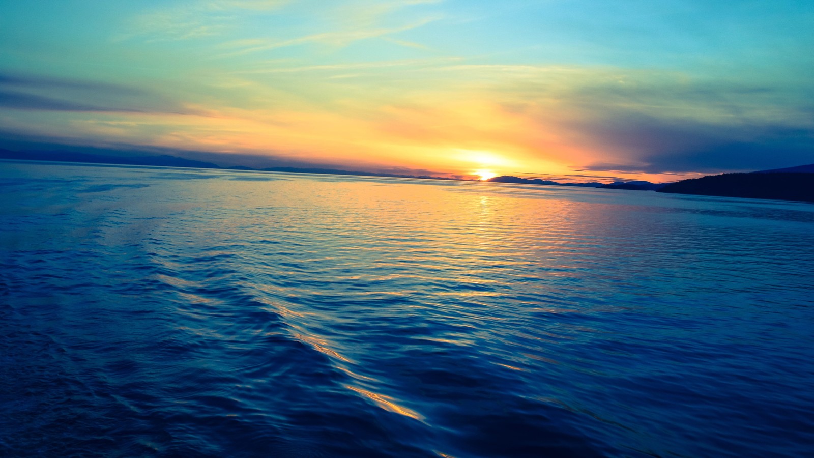 A view of a sunset over a body of water with a boat in the distance (sunset, sunrise, evening, cloud, water)