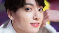 Jungkook's Charismatic Smile and Playful Charm