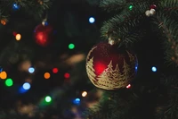 Festive Christmas Tree Ornaments Amidst Colorful Lights