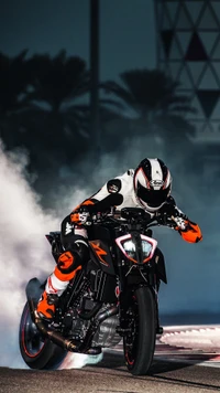 KTM RC 390 motorcycle performing a burnout with a rider in a racing helmet and gear, showcasing dynamic movement and automotive power.