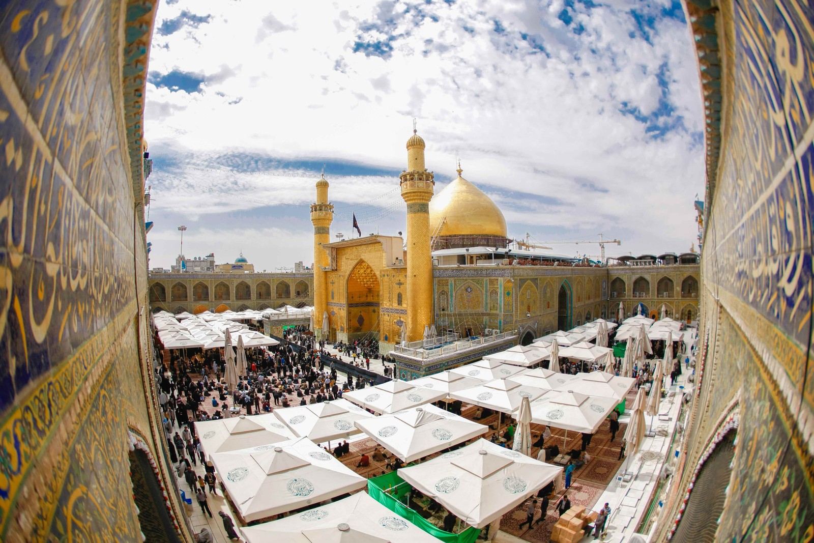 Arafed view of a mosque with a lot of tables and umbrellas (ali ibn abi talib, allah, amir al momenin, emam ali, god)