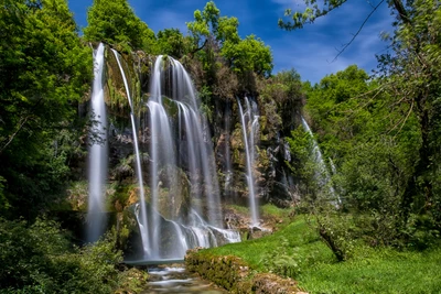 Majestic Waterfall Cascading Through Lush Greenery in Plitvice Lakes National Park