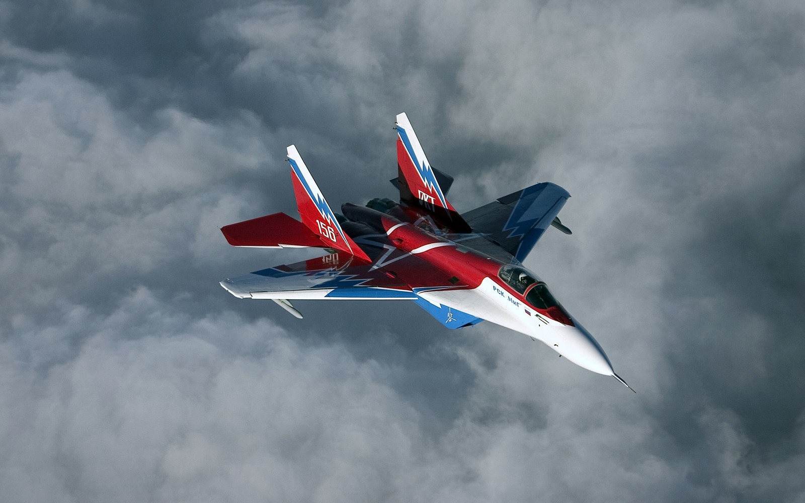 There is a red, white and blue jet flying through the sky (military aircraft, airplane, aircraft, fighter aircraft, aviation)