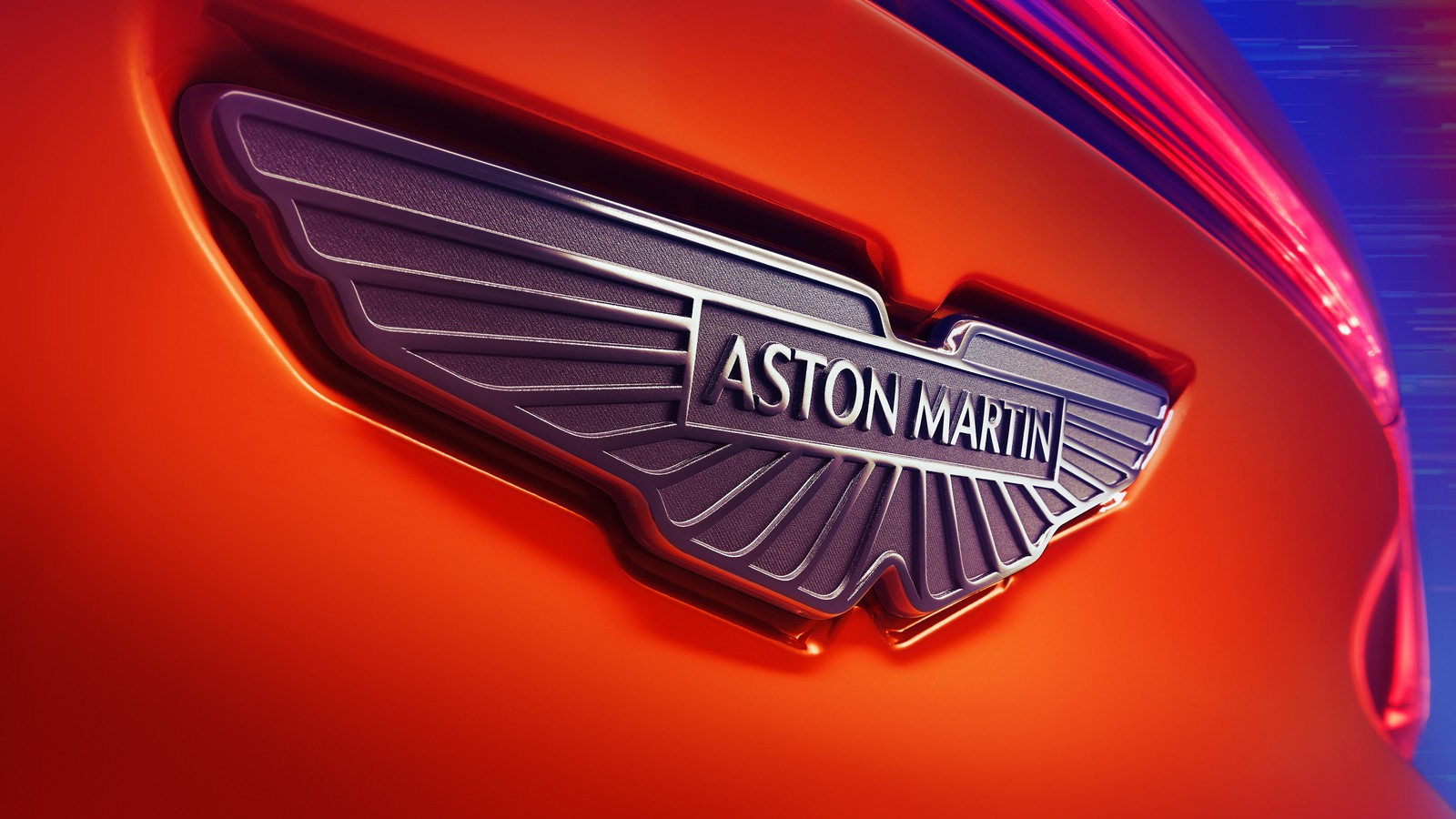 A close up of a car with a aston logo on it (aston martin dbx707, logo, 2024, 5k, 8k)